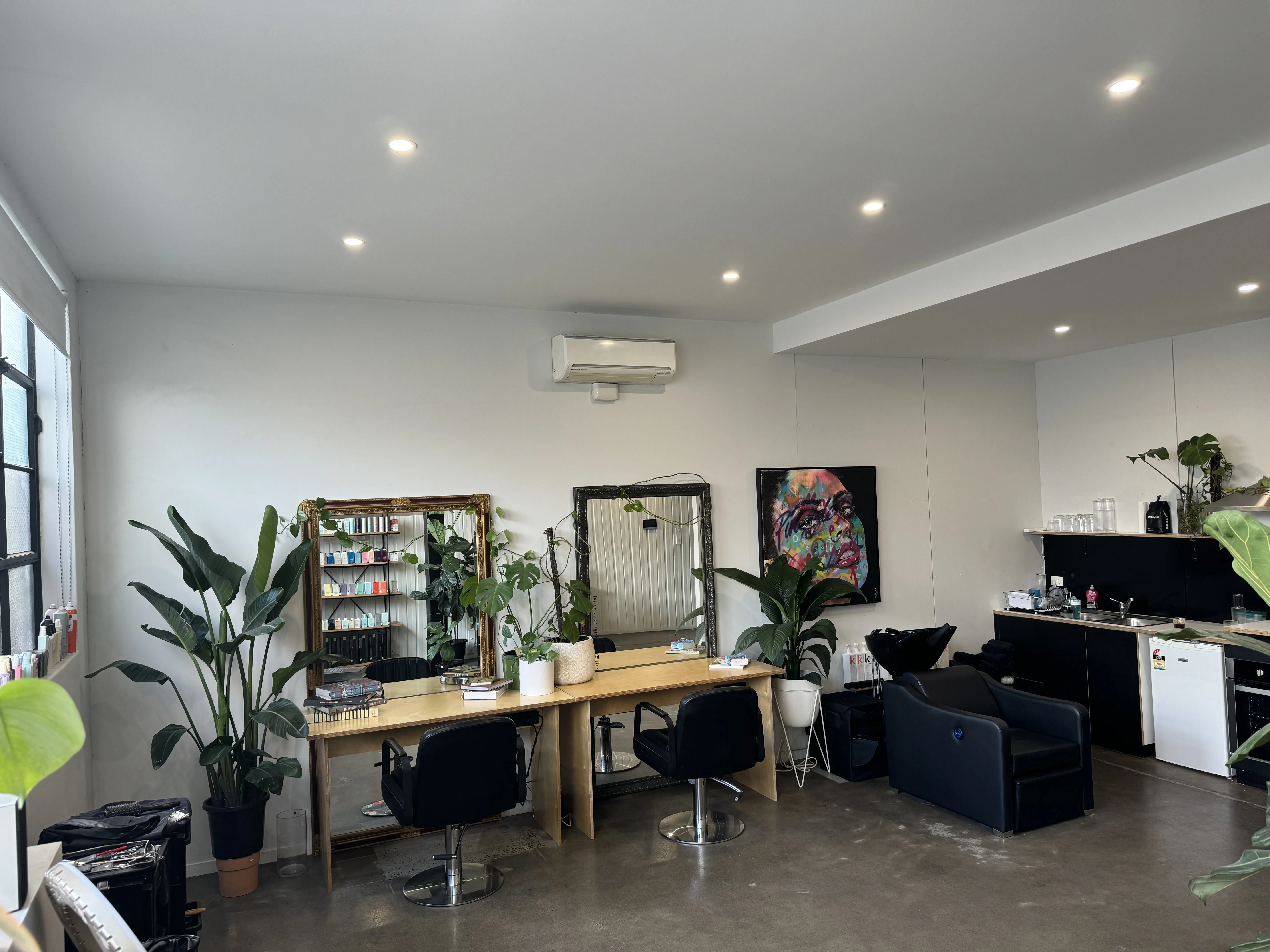Ziyad Salon — dual styling stations with ornate mirrors, wash basin and colourful graffiti wall art